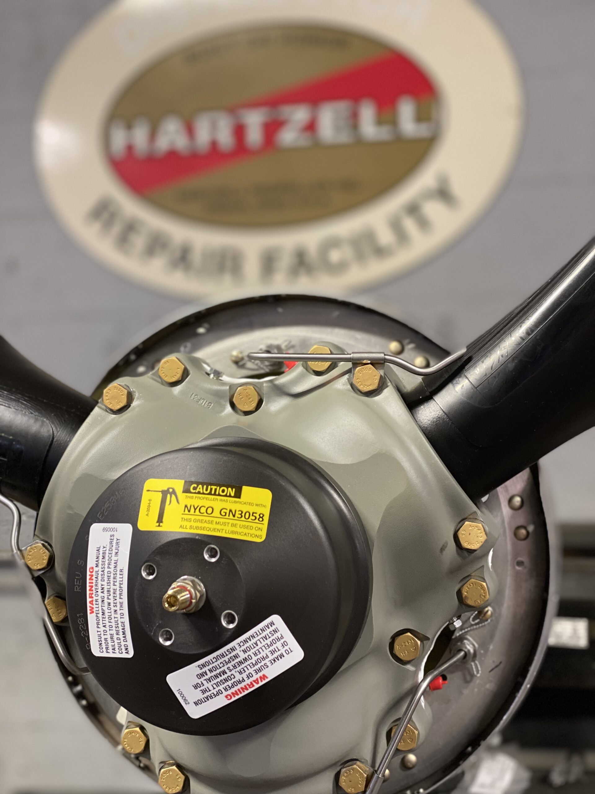 Detailed close-up of a steering wheel showcasing a sticker, emphasizing the wheel's craftsmanship and the sticker's placement.